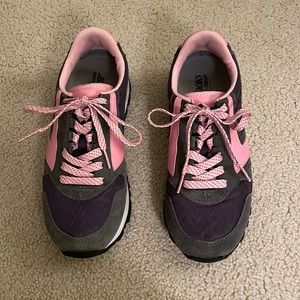 Barley worn purple, pink, and gray Brooks sneakers.
